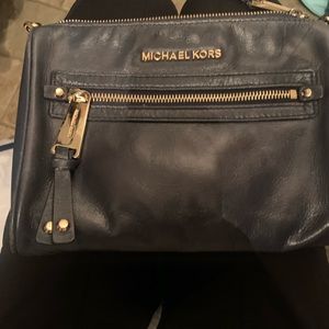 Michael Kobe’s navy cross body with gold accents